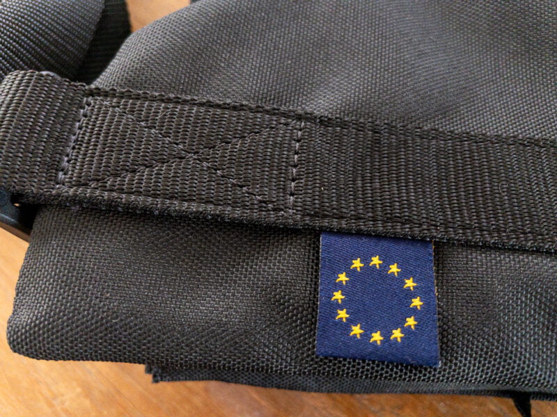 Close-up of sewed strap on cordura with a label of the EU flag